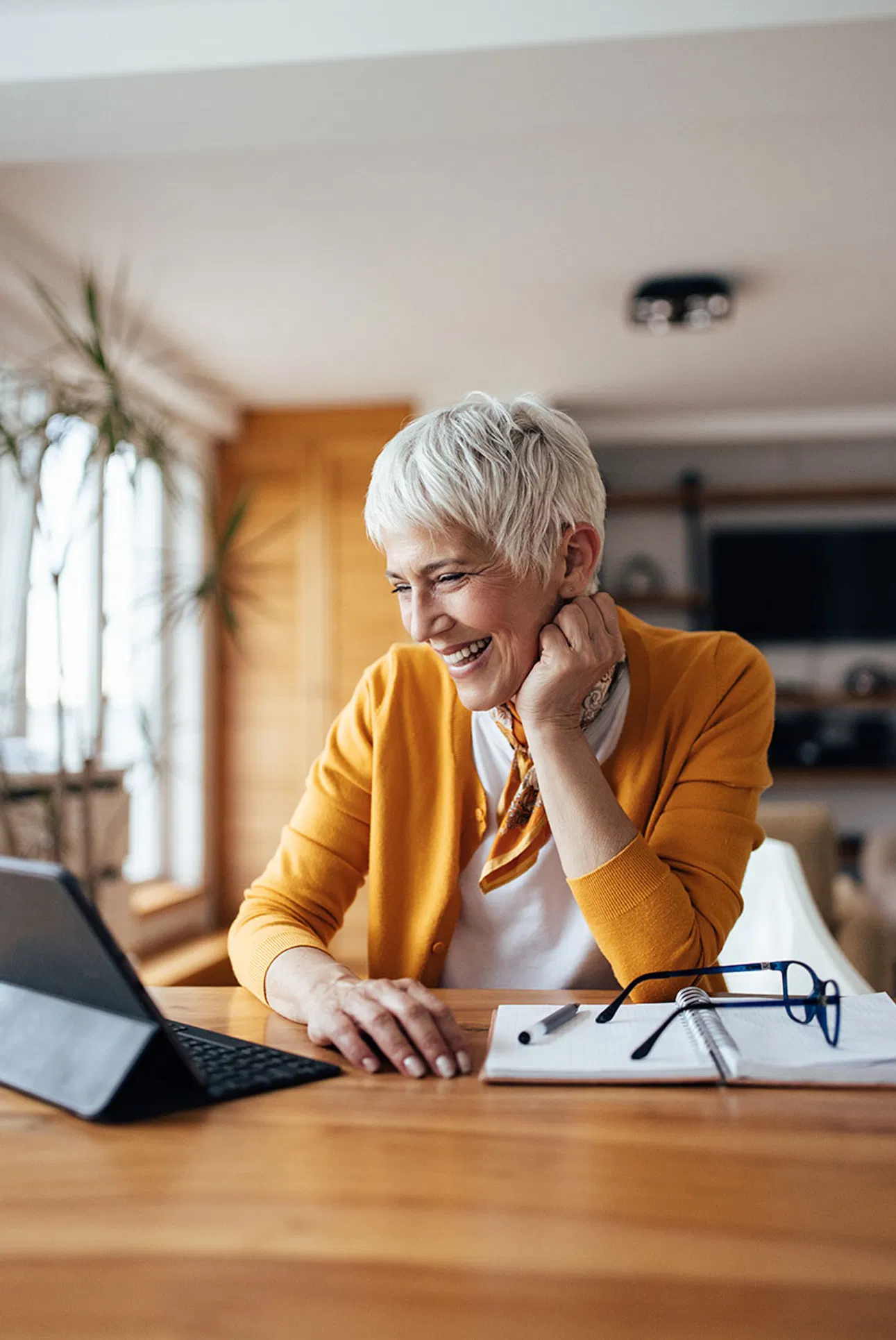 Smiling property owner using a tablet to access real-time property management information